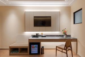 a kitchen with a counter and a chair in a room at NiK Hotel Thi Sach in Ho Chi Minh City +44 photos