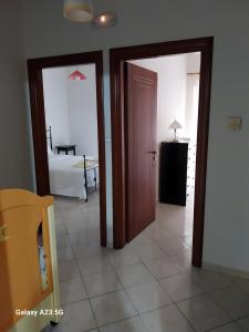 a room with two doors and a bedroom with a bed at Menidi apartment 202 in Menídion +11 photos