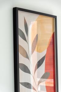 a framed painting of a plant at Warm cocoon - parking included in Asnières-sur-Seine