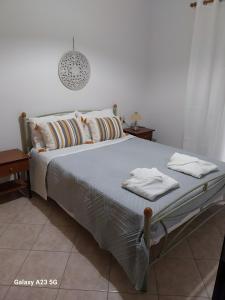 a bedroom with a bed with towels on it at Menidi Apartment 201 in Menídion