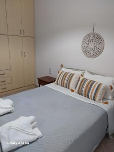 a bedroom with a large bed with towels on it at Menidi Apartment 201 in Menídion