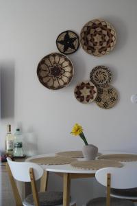 a dining room table with plates on the wall at Harmonia Horyniec in Horyniec