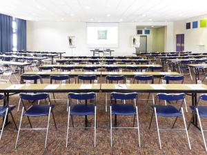 an empty room with tables and chairs in a classroom at ibis Styles Arles Palais des Congrès in Arles +89 photos