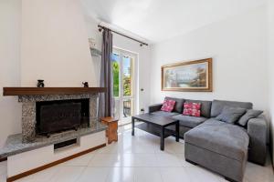 a living room with a couch and a fireplace at Casa Ezia in Porlezza