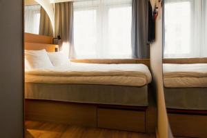 a small bedroom with a bed and a window at Scandic Go, Kungsgatan 14 in Jönköping