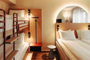 a bedroom with two bunk beds and a table at Scandic Go, Kungsgatan 14 in Jönköping