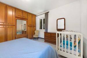 a bedroom with a bed and a dresser and a mirror at Casa Ezia in Porlezza