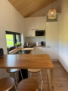 a kitchen with a wooden table and some chairs at Oaza Żuraw in Miłki +20 photos