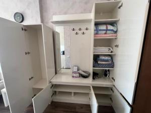 a bathroom with a white vanity with a mirror at Gio apartment in Angisa