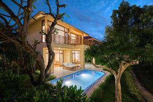 a villa with a swimming pool in front of a house at Ana Mandara Cam Ranh in Cam Ranh +199 photos