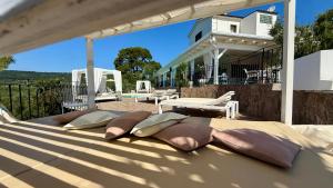 a group of pillows sitting on top of a bed at B&B Borgo del Nespolo in Peschici