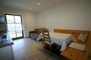 a living room with a table and a couch at Hilpoldhof in Castelrotto