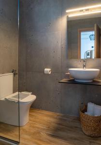 a bathroom with a sink and a toilet and a mirror at Australia in Skiathos +29 photos