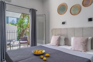a bedroom with a bed with a bowl of fruit on it at Australia in Skiathos