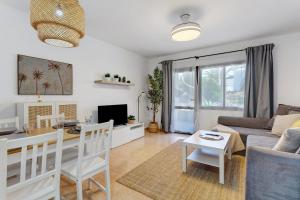 a living room with a couch and a table at Oasis Duna _ Estrella Del Mar Pool in Corralejo