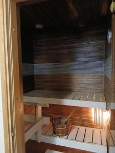 a sauna with a bucket in the middle at Apartment in Raahe