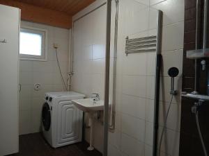 a bathroom with a sink and a washing machine at Apartment in Raahe