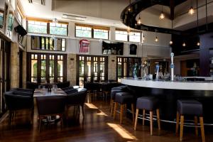 a restaurant with a bar and tables and chairs at Aphrodite Hills Hotel and Resort in Paphos