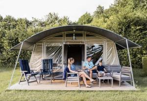 a group of people sitting in a gazebo at Camping Begur - Luxe Lodge in Begur