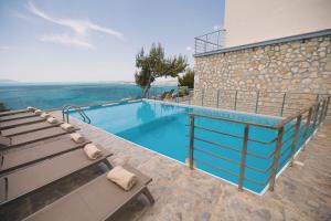 a swimming pool with a bench next to a building at Vila Dena in Vlorë