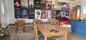 a room with a table and chairs and posters on the wall at Groennebaek Bed and Breakfast in Føvling +20 photos