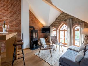 a living room with a brick wall at Stilvolles Wellnes-Refugium mit Privatsauna, Whirlwanne & Kamin im historischen Gut in Großharthau