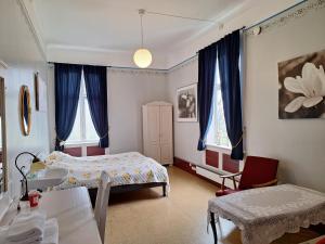 a bedroom with a bed and a table and chairs at Tjøtta Gjestegaard in Alstahaug