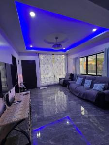 a living room with a couch and a blue ceiling at Rams home in Moalboal