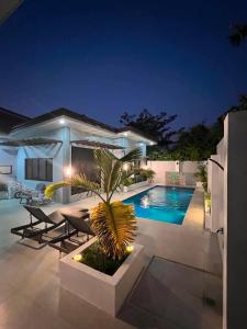 a house with a swimming pool at night at Rams home in Moalboal