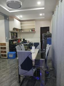 a room with a table and chairs in a room at Rams home in Moalboal