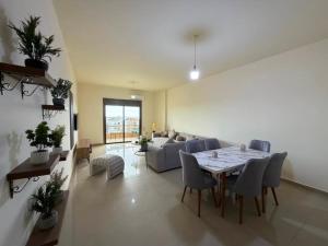 a living room with a table and a couch at Batroun sunset guesthouse in Batroûn