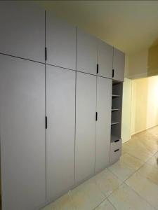 a white closet with white cabinets in a room at Batroun sunset guesthouse in Batroûn