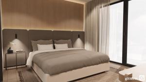 a bedroom with a large bed and a large window at Augusta Apartments in Fliess