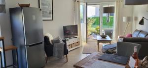 a living room with a stainless steel refrigerator at rosmarin-am-sund in Altefähr