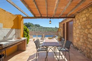 an outdoor patio with a table and chairs at Casa Rural Ca La Siona in Avinyonet