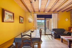 a living room with a dining table and a couch at Casa Rural Ca La Siona in Avinyonet