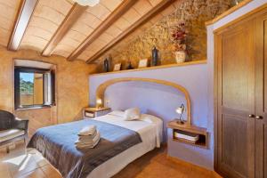 a bedroom with a bed in a room at Casa Rural Ca La Siona in Avinyonet +31 photos