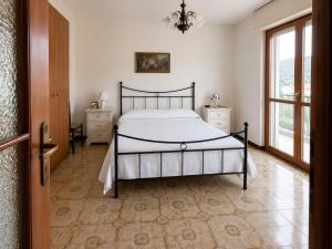 a bedroom with a bed and a large window at Casa Eliana - Camporosso in Camporosso