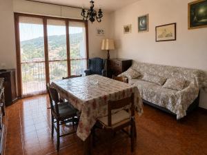 a living room with a table and a couch at Casa Eliana - Camporosso in Camporosso