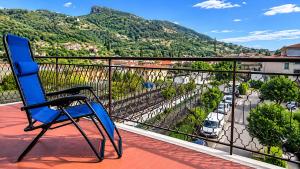 a blue chair sitting on a balcony with a view at Casa Eliana - Camporosso in Camporosso