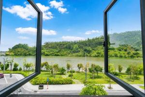a view of a river from a window at The Muse Hotel 3 in Ðố Sơn +102 photos