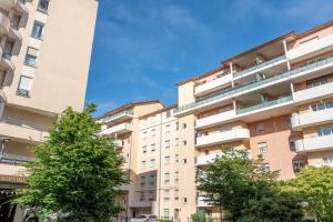 an apartment building with trees in front of it at Le Jardin de l'Atrium - Appartement moderne proche de Genève et Palexpo in Saint-Julien-en-Genevois