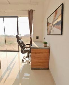 an office with a desk and a chair in a room at Oasis Murthal Open Field Views in Indraprast +7 photos