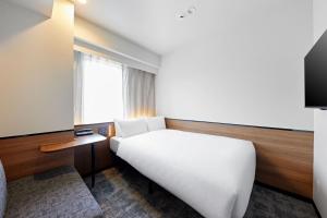 a hotel room with a bed and a window at Sotetsu Grand Fresa Osaka-Namba in Osaka +98 photos
