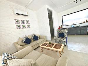 a living room with a couch and a coffee table at Oasis Murthal Open Field Views in Indraprast