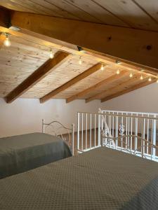 a bedroom with a bed and a wooden ceiling with lights at Il Borghetto in Palinuro