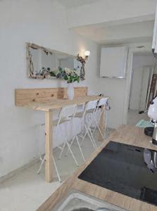 a table with a mirror and a vase with flowers at Il Borghetto in Palinuro +19 photos