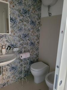 a bathroom with a toilet and a sink at Il Borghetto in Palinuro