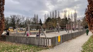 a group of children playing in a playground at Le Pegan - Appartement 2 chambres proche du centre de Ferney et de Palexpo in Ferney-Voltaire +11 photos