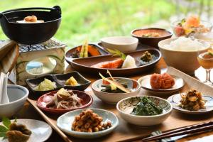 a table topped with different types of food in bowls at 六日町温泉 龍氣 in Minami Uonuma
